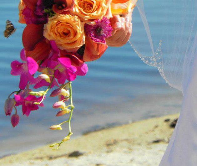 Wedding bouquet of orange roses and pink orchids