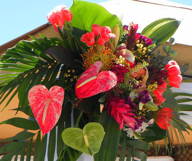 Tropical bouquet with red anthuriums and foliage