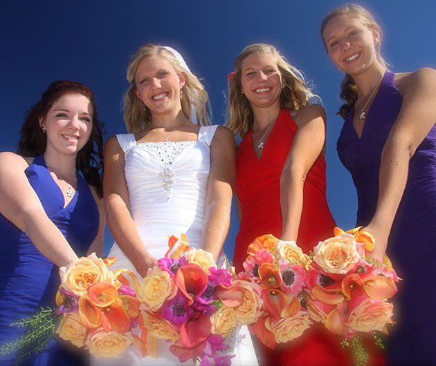 Bride and bridesmaids holding colorful bouquets