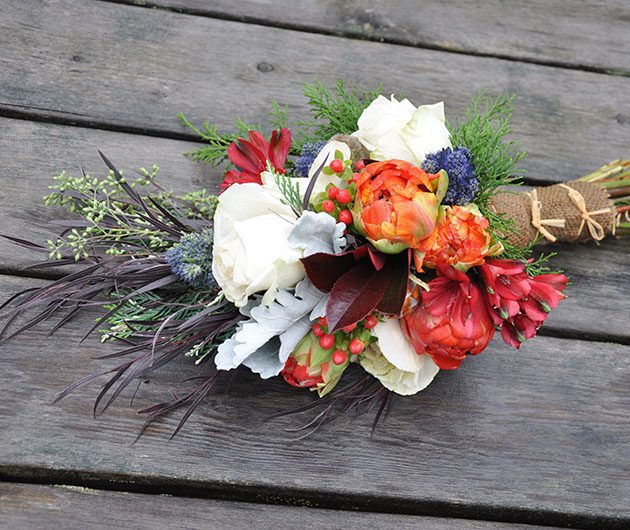 Colorful bouquet of flowers on wooden planks