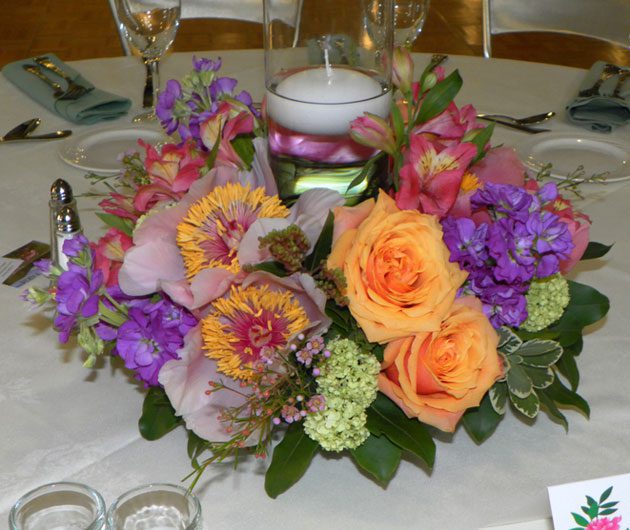 Colorful floral centerpiece with floating candle