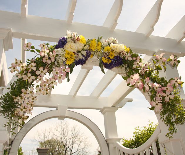 Wedding arch with floral garland on pergola