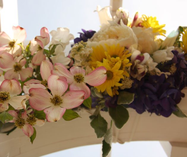 Colorful spring wedding floral arrangement on arch