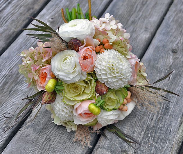 Pastel wedding bouquet on weathered wooden boards