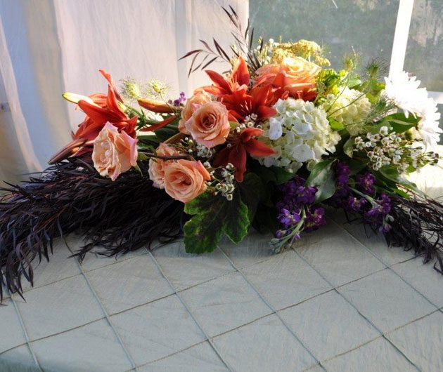 Peach roses and orange lilies floral centerpiece