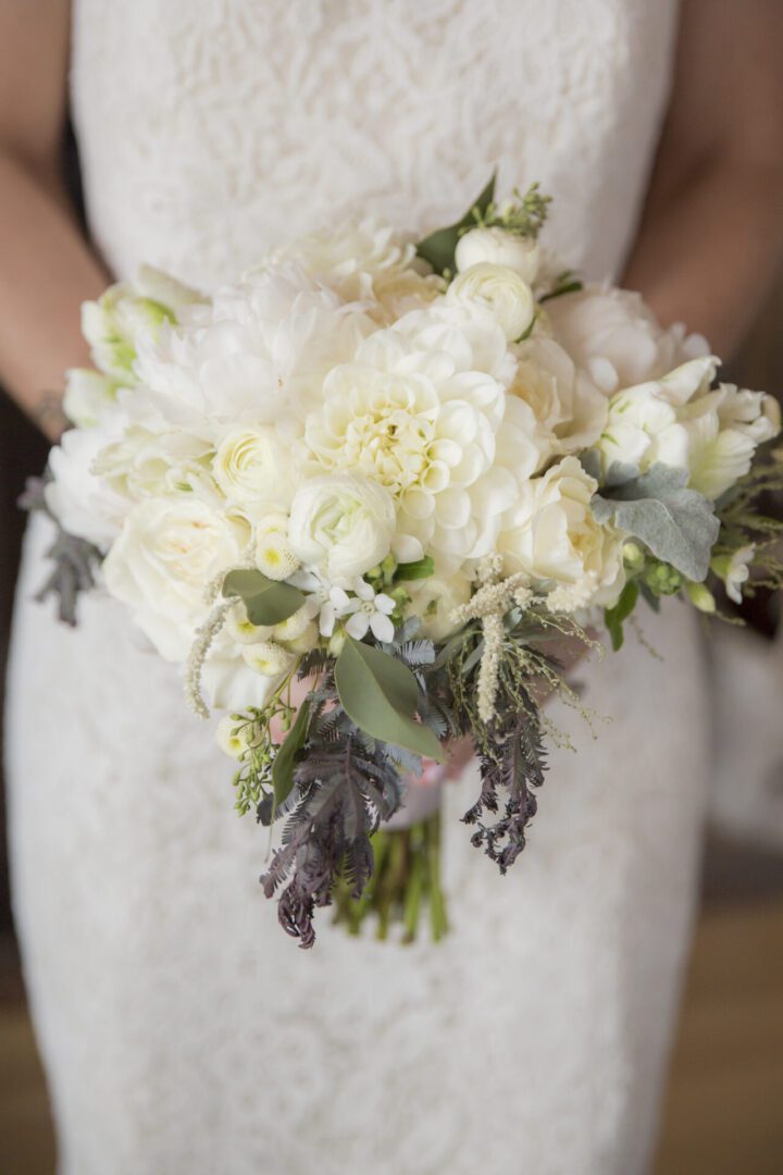 Bride holding white wedding bouquet