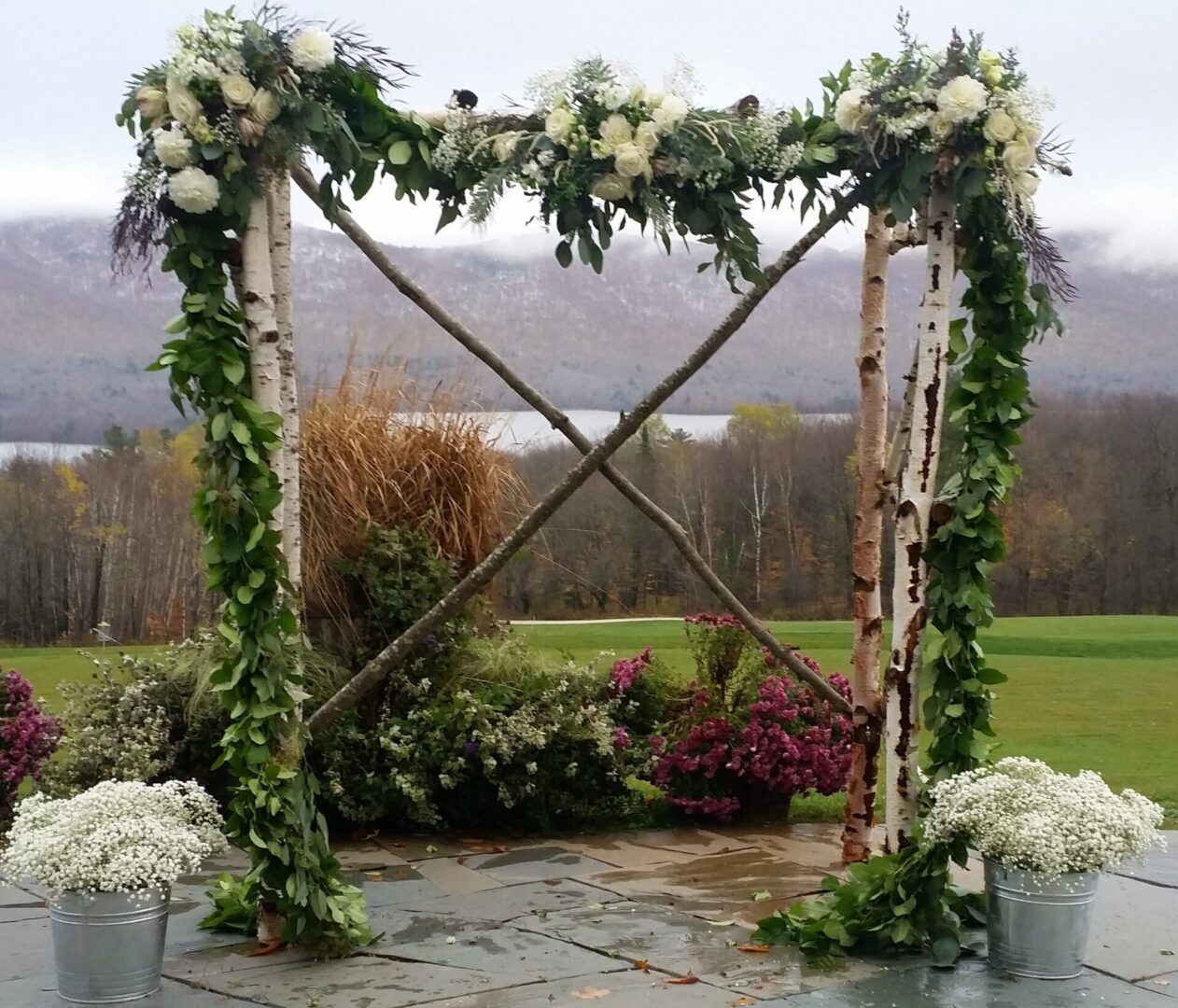 Rustic birch wedding arch with white flowers