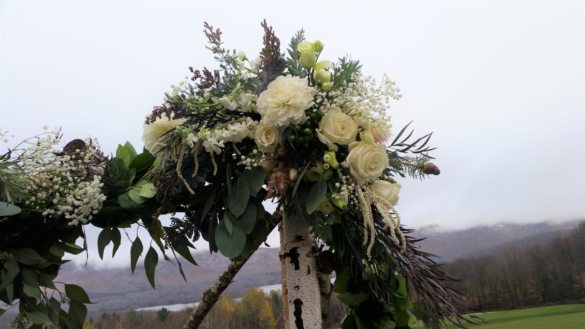 White rose and greenery wedding arch