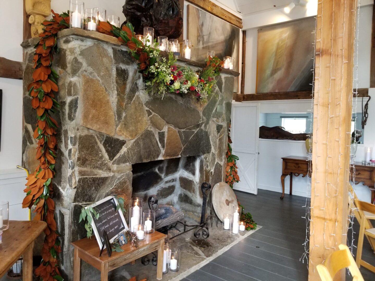Rustic stone fireplace with candles and garland