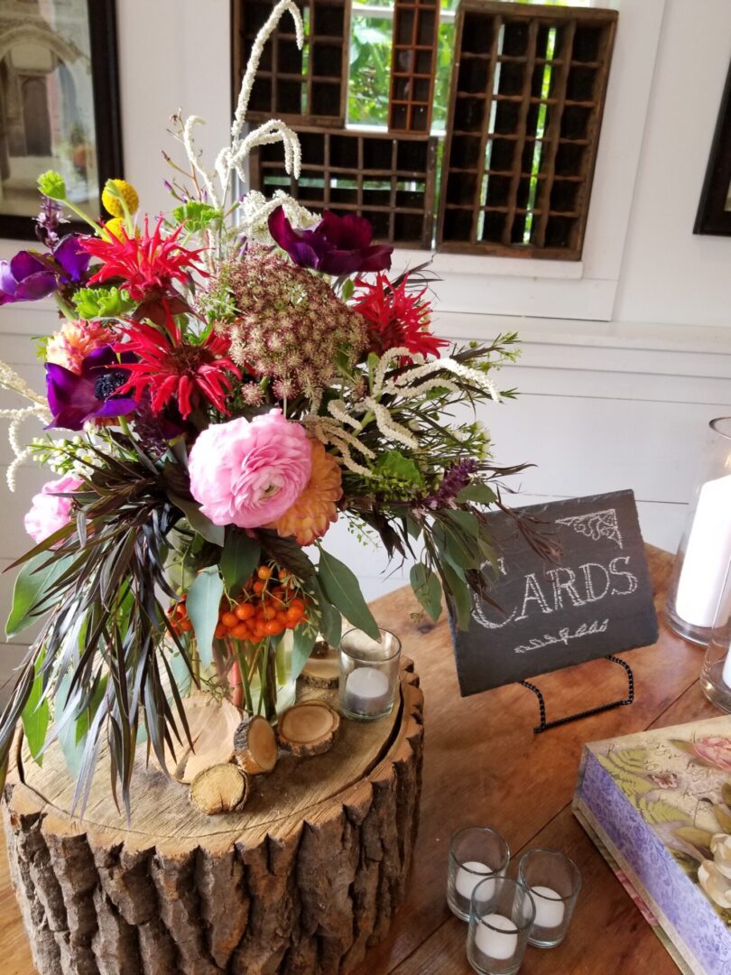 Rustic floral centerpiece with cards sign