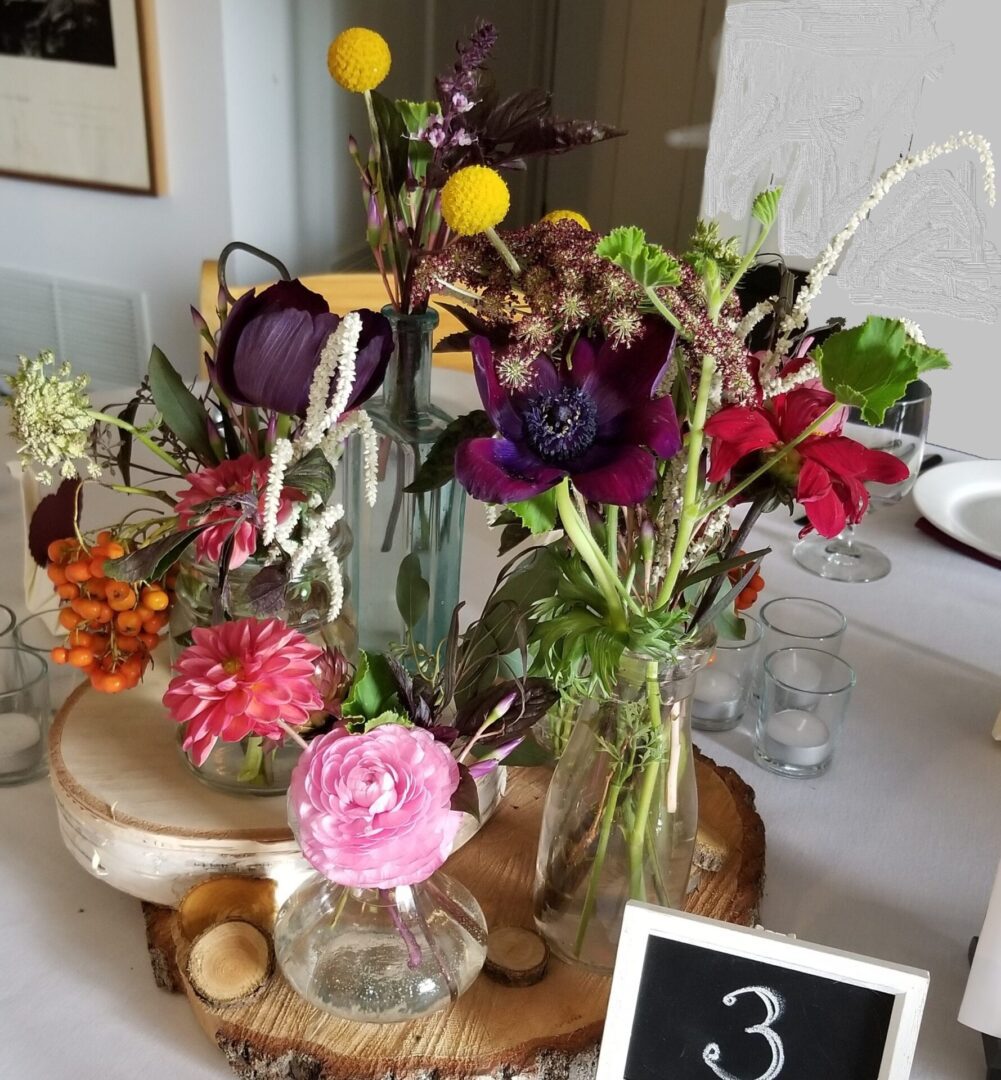 Colorful wildflower bouquets in vases on table