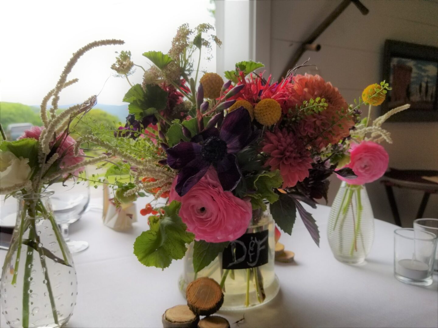 Colorful mixed floral centerpiece in glass vase