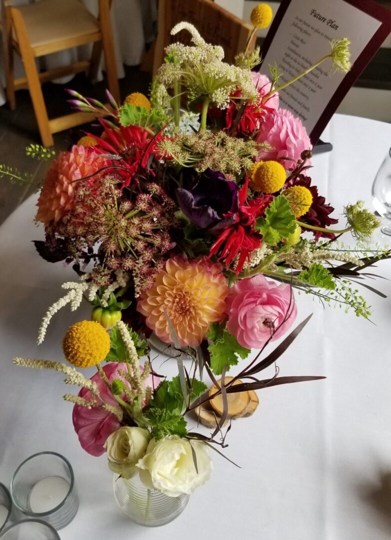 Colorful mixed floral centerpiece on table