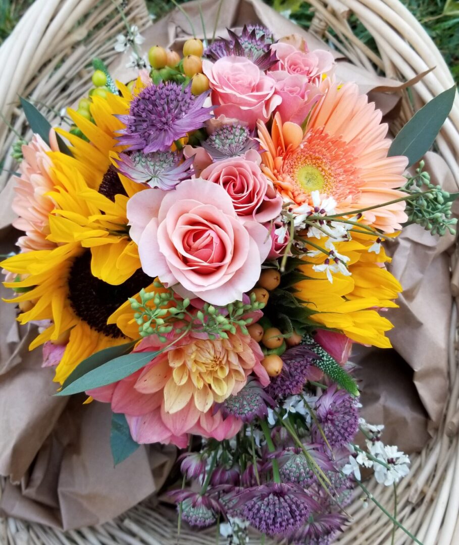 Colorful mixed bouquet with sunflowers and roses