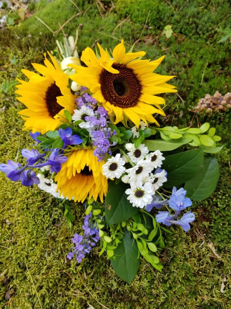 Sunflower bouquet with purple and white blooms