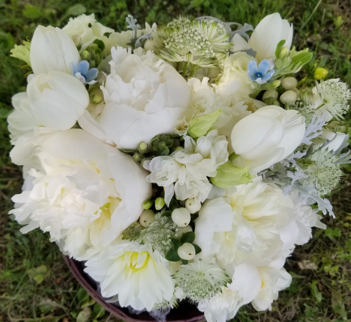 White peony bouquet with small blue flowers