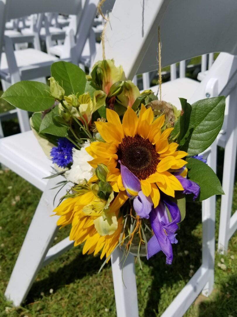 Sunflower bouquet tied to white chair