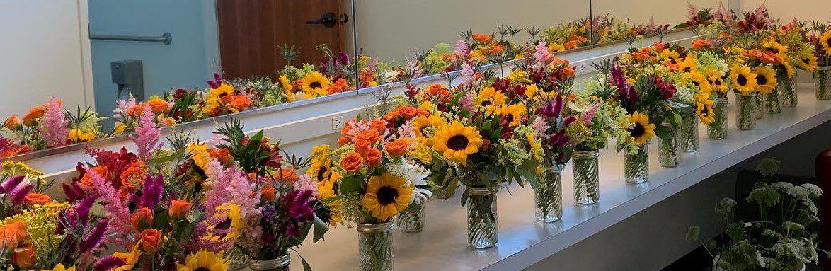 Row of sunflower bouquets in glass jars