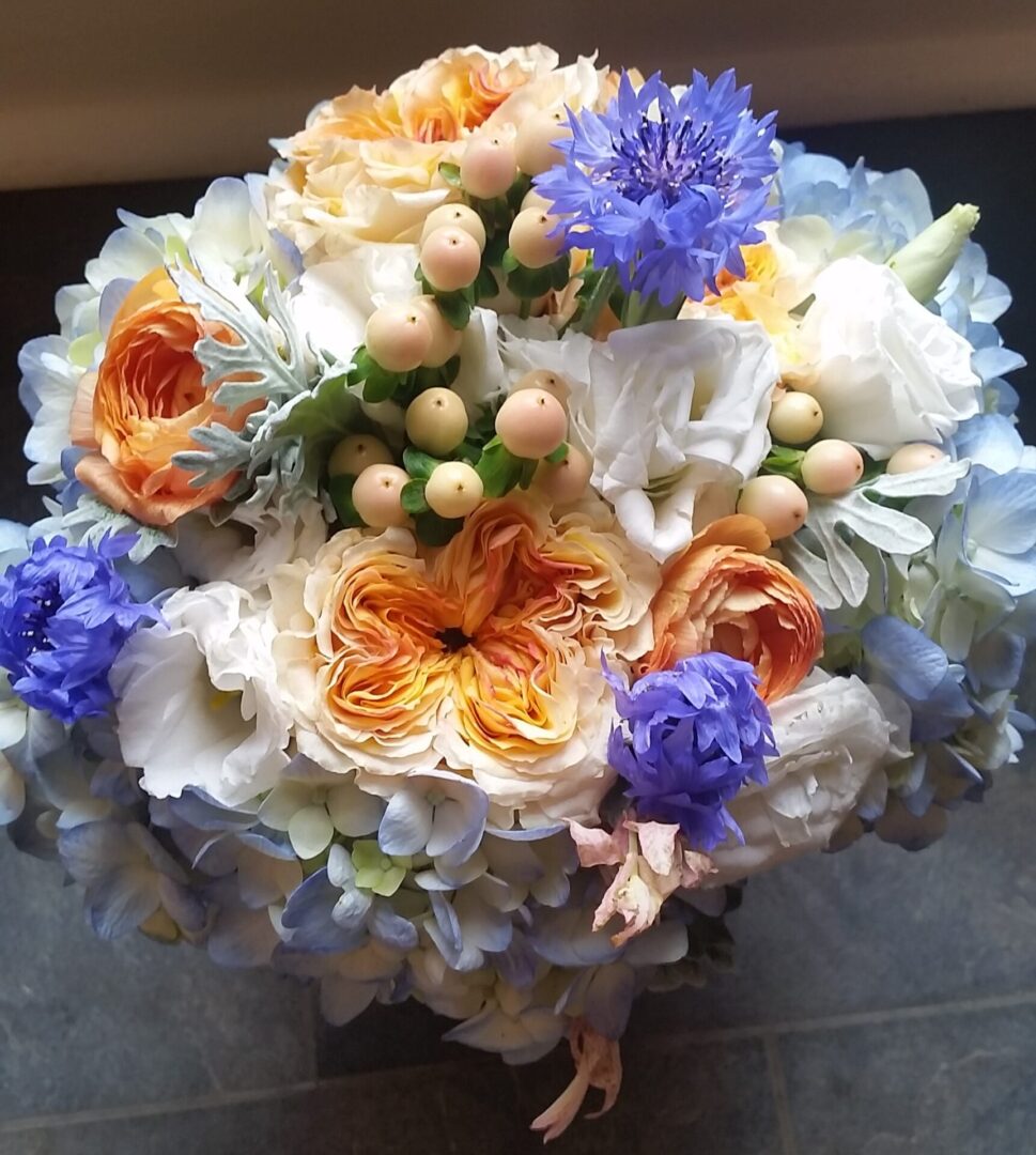 Orange and blue mixed floral bouquet